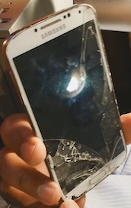A broken samsung phone with a smashed screen